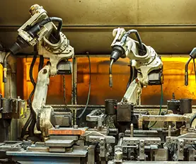 Robotic arms welding in an industrial factory